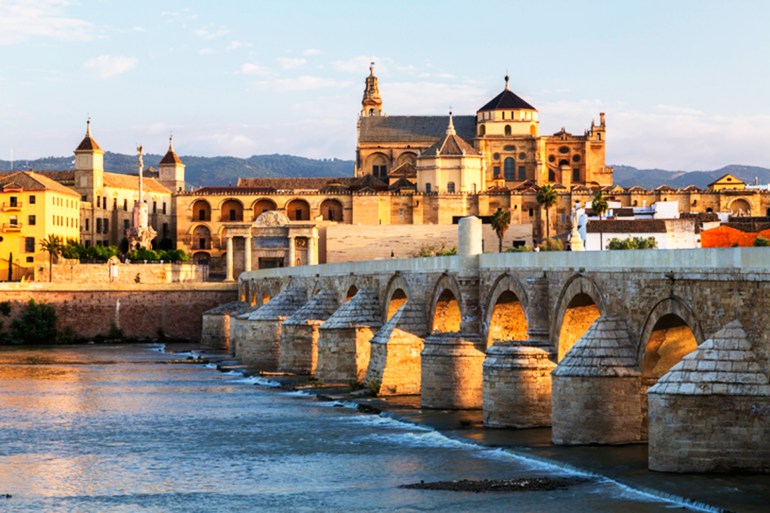 Arches of urban bridge in Cordoba cityscape, Andalusia, Spain - stock photo