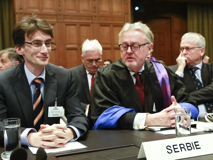 Members of the Serbian delegation, First Counsellor Sasa Obradovic, left, William Schabas, center and Andreas Zimmermann, right, await the start of public hearings at the International Court of Justice (ICJ) in The Hague, Netherlands, Monday, March 3, 2014. Croatia is accusing Serbia of genocide during fighting in the early 1990's as the former Yugoslavia shattered in spasms of ethnic violence, in a case at the United Nations' highest court that highlights lingering animosity in the region. Croatia is asking the ICJ to declare that Serbia breached the 1948 Genocide Convention when forces from the former Federal Republic of Yugoslavia attempted to drive Croats out of large swaths of the country after Zagreb declared independence in 1991. (AP Photo/Jiri Buller)