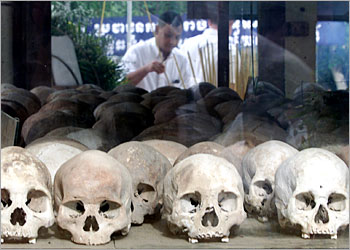 A Cambodian villager prays at a memorial stupa filled with more than 8,000 skulls of the victims of the Khmer Rouge at Choeung Ek, a "killing fields" site, located on the outskirts of Phnom Penh during a "Day of Rememberance" ceremony on May 20, 2003. Thousands of Cambodians including 500 monks gathered at the site to remember those who perished during the radical communist group's 1975-79 regime. Atotal of 129 mass grave were found at Choeung Ek after the Khmer Rouge were driven from power when Vietnamese troops invaded Phnom Penh in early January 1979. REUTERS/Chor Sokunthea
