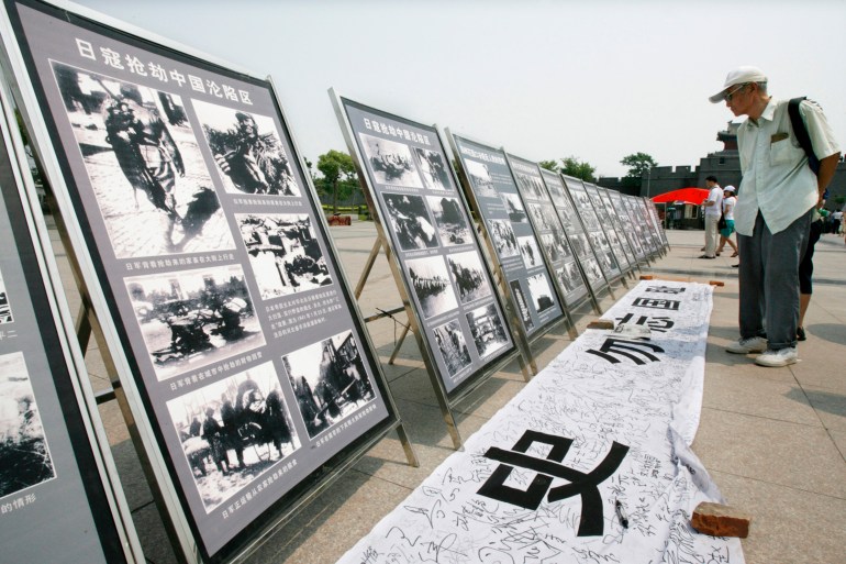 Visitors look at wartime photographs displayed at Marco Polo Bridge on the outskirts of Beijing July 7, 2007. About 1,000 people attended a ceremony marking the 70th anniversary of the outbreak of war against Japan at a museum near the Marco Polo Bridge in suburban Beijing, followed by the opening of an exhibit. Beijing schoolchildren, survivors, and officials honoured those killed in the Marco Polo Bridge incident in which Chinese and Japanese troops fired shots on July 7, 1937 sparking war. REUTERS/Claro Cortes IV (CHINA)