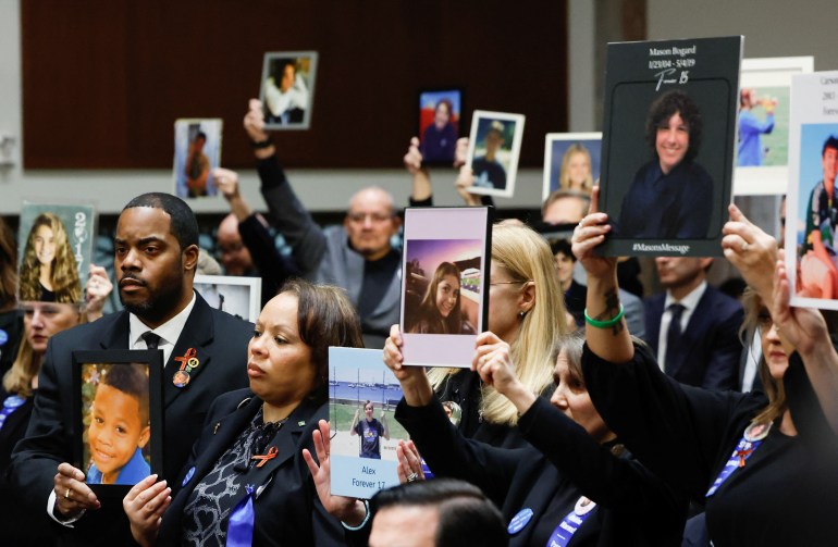 People hold up photographs and placards during the Senate Judiciary Committee hearing on online child sexual exploitation at the U.S. Capitol in Washington, U.S., January 31, 2024. REUTERS/Evelyn Hockstein