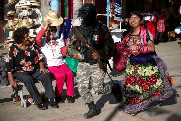A local self defense force member dances during the Purépecha New Year celebration in Ocumicho, Michoacán state, Mexico, on 1 February 2024. - Every year, Purepecha’s Indigenous people from different regions of Michoacan State celebrate the Fuego Nuevo Purepecha (Purepecha’s New Fire), a fire lighting ceremony to mark the start of the new year. (Photo by Rodrigo Oropeza / AFP)