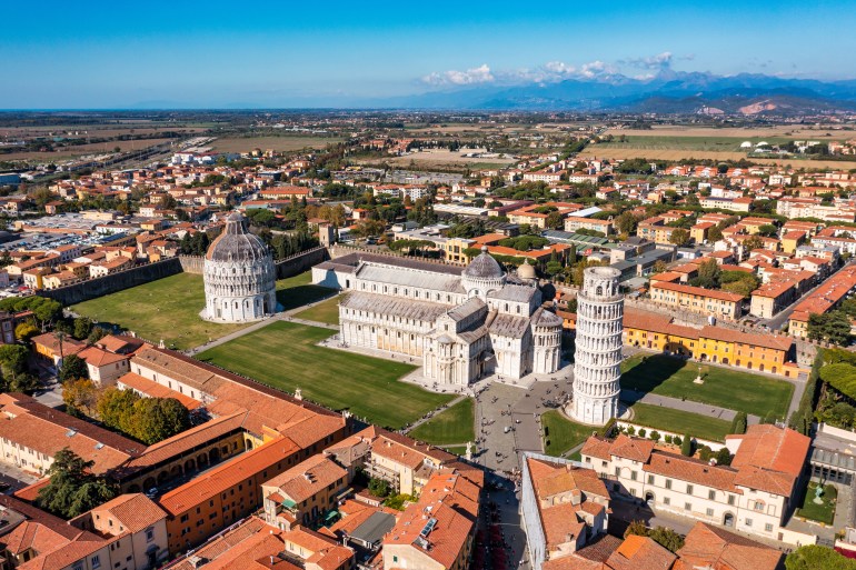 Pisa Cathedral and the Leaning Tower in a sunny day in Pisa, Italy. Pisa Cathedral with Leaning Tower of Pisa on Piazza dei Miracoli in Pisa, Tuscany, Italy.