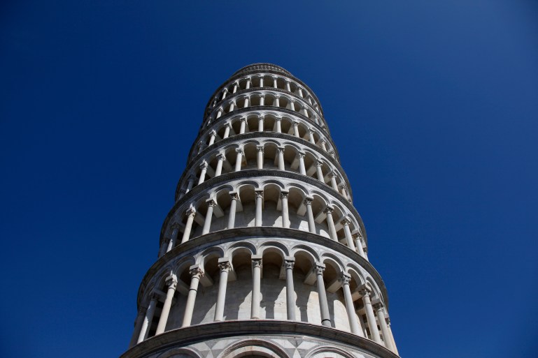 The Leaning Tower of Pisa is seen against blue skies