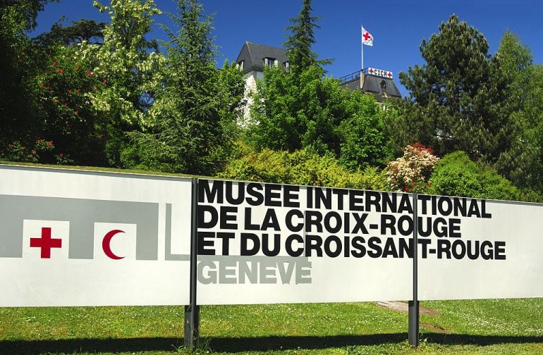 At the entrance to the International Red Cross and Red Crescent Museum in Geneva, headquarters of the International Committee of the Red Cross, ICRC, with the Red Cross flag in the back, Geneva, Switzerland. (Photo by: MyLoupe/Universal Images Group via Getty Images)