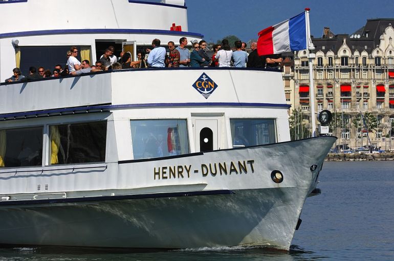 Tourists on board of the excursion ship Henry Dunant of the Compagnie Generale de Navigation sur le lac Leman (CGN) with the French tricolour in bow in the Rade port basin of Geneva, Lake Geneva, Geneva, Switzerland. (Photo by: MyLoupe/Universal Images Group via Getty Images)