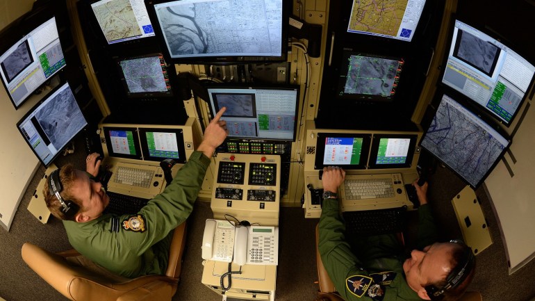 WADDINGTON, ENGLAND - JANUARY 15: Operators FLT LT Tom Maddock (L) and Master Rear Crew David Gaul sit in one of the Ground Control Stations at RAF Waddington on January 15, 2014 in Waddington, England. RAF Waddington has two Ground Control Stations operating unmanned aircraft systems in Afghanistan, including the RAF's Reaper aircraft. The unmanned aircraft systems, often referred to as drones, include current and future equipment such as Hermes 450, Black Hornet Nano, Tarantula Hawk, Watchkeeper and Scan Eagle. (Photo by Nigel Roddis/Getty Images)