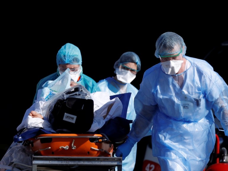 A patient infected with coronavirus is carried on a stretcher by a French rescue team before being transferred by a helicopter of the civil security (Securite Civile) from Strasbourg university hospital to Pforzheim in Germany as the spread of the coronavirus disease (COVID-19) continues, in France, March 24, 2020. Picture taken March 24, 2020. REUTERS/Christian Hartmann