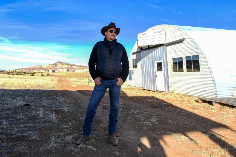 David Manzanares, actor, 2nd Unit Director, producer, location Manager poses on the set where director Christopher Nolan shot his Oscar nominated movie ìOppenheimerî, in Abiqui˙, New Mexico, on February 20, 2024. - An entire town filled with nuclear laboratories, built from scratch in the remote mountains of New Mexico, with every single person involved sworn to secrecy? It is not just the plot of "Oppenheimer," but also the story of how Christopher Nolan's Oscar-nominated movie about the invention of the atomic bomb was made. "This is the most I've ever spoken about it," said David Manzanares, field producer for Ghost Ranch, as he took AFP on a recent tour of the location for the movie's Los Alamos scenes. "It definitely took on the air of secrecy," he recalled. (Photo by VALERIE MACON / AFP)