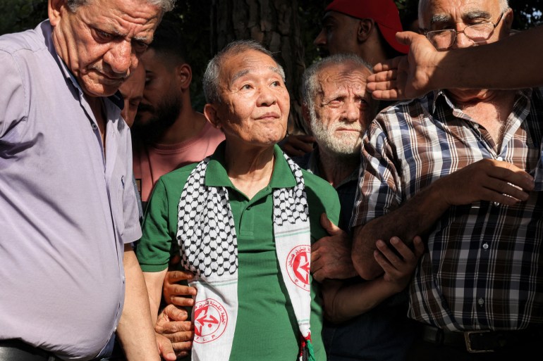 Kozo Okamoto (C) -- the only surviving member of the three-man "Japanese Red Army" (JRA) commando unit that killed 26 people in an attack on Israel's Lod airport on May 30, 1972 -- attends a ceremony organised by Palestinian militants to mark the 50th anniversary of the Lod attack in Lebanon's capital Beirut on May 30, 2022. Palestinian militants in Beirut on May 30 marked the 50th anniversary of a deadly attack carried out by members of the Japanese Red Army at Israel's Lod airport. Kozo Okamoto, the only surviving member of the three-man commando that killed 26 people (including 17 Christian pilgrims from Puerto Rico) on May 30, 1972, made a rare appearance at the ceremony. The attack was planned by the Popular Front for the Liberation of Palestine (PFLP), which has commemorated it every year for a half a century. (Photo by JOSEPH EID / AFP)