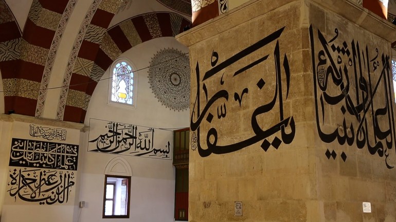 كتابات متنوعة على جدران الجامع وأعمدته (الأناضول)