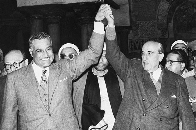 (Original Caption) 2/3/1958-Cairo, Egypt- Egyptian President Gamal Abdel Nasser, left, and Syrian President Shukri Al-Kuwatly clasp hands to symbolize merger of the two countries into the United Arab Republic on Kuwatly's arrival in Cairo with members of his cabinet. In their proclamation, the two leaders left "the door open for participation by any other Arab state desirous of joining in the union" or federation. An Egyptian spokesman said today that the kingdom of Yemen, an absolute monarchy, is expected to "adhere" immediately to the new Egypt-Syrian Republic.