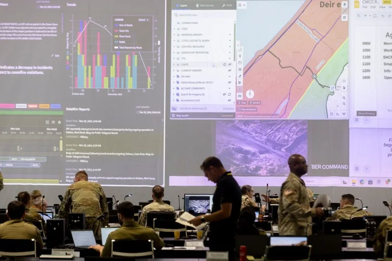KIRYAT GAT, ISRAEL - NOVEMBER 20: U.S. Army personnel, IDF personnel and others international officials monitor screens displaying maps and imagery of the Gaza Strip during a media tour inside the Civil-Military Coordination Center (CMCC) on November 20, 2025 in Kiryat Gat, Israel. The American-led military facility 13 miles north of the Gaza Strip is where U.S. and Israeli soldiers, along with foreign diplomats and NGO representatives, are monitoring the ceasefire in Gaza and discussing the future of the Palestinian territory. Critics have noted the lack of formal Palestinian representation in the CMCC. (Photo by Amir Levy/Getty Images)