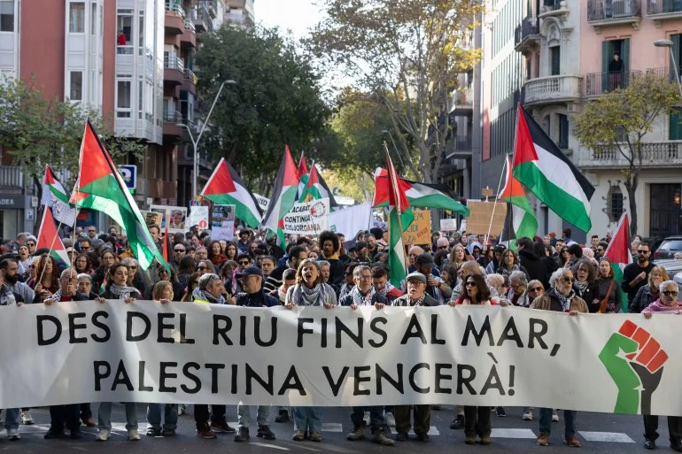 epa12556846 People wave flags and hold a banner reading 'From the river to the sea, Palestine will prevail' as they participate in a rally in support of the Palestinian people during the 'International Day of Solidarity with the Palestinian People' in Barcelona, Spain, 29 November 2025. In 1977, the UN General Assembly designated 29 November as the International Day of Solidarity with the Palestinian People, urging annual events, exhibitions, and broad support to promote Palestinian rights. EPA/MARTA PEREZ